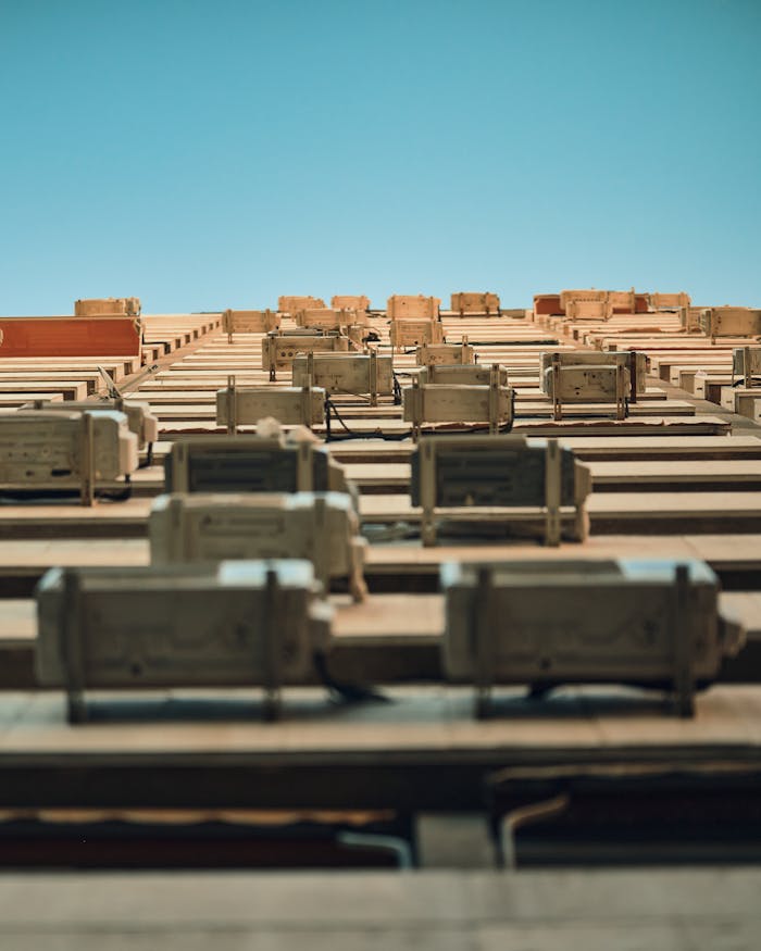 Services Low angle view of a building façade with multiple air conditioners against a clear sky.