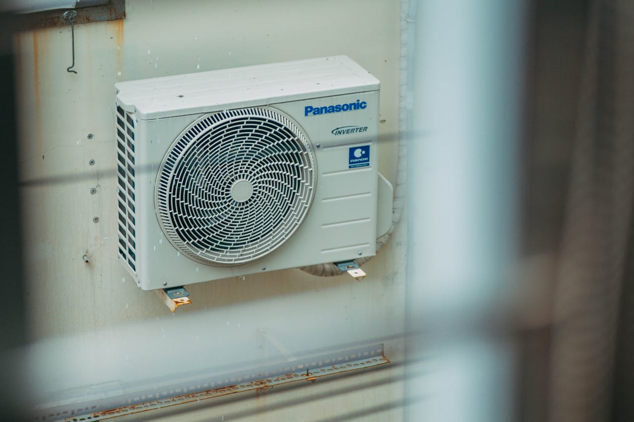 About Air conditioner unit mounted outdoors on a building wall, showcasing modern HVAC technology.